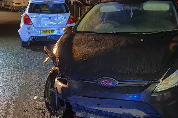 CCTV shows car pursued by police smashing into parked vehicles