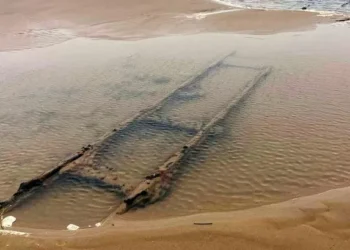 Hidden railway exposed by tide at popular Welsh beach