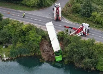 On the edge! Desperate rescue as Waitrose lorry hangs over lake